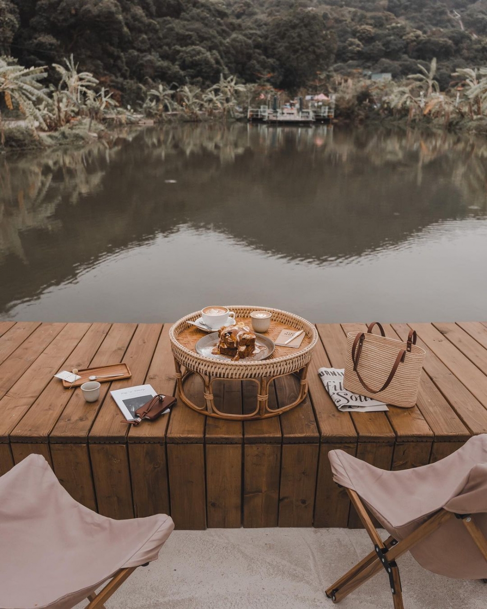 坐在魚塘旁，凝視著山水美景。