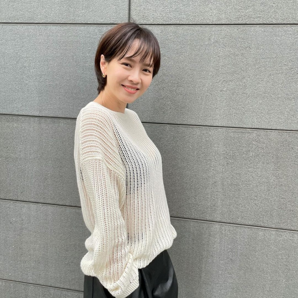 簍空針織衫搭配黑色的小背心。