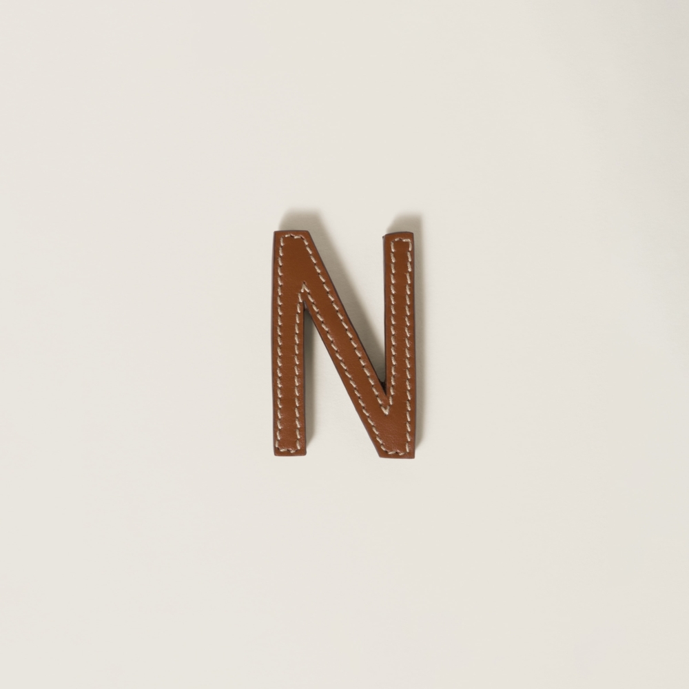 Leather and metal brooch